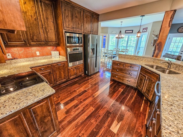 2971 Ownby Rd, Lewisburg, TN 37091 - kitchen featuring dark wood finished floors, a sink, light stone counters, a notable chandelier, and stainless steel appliances