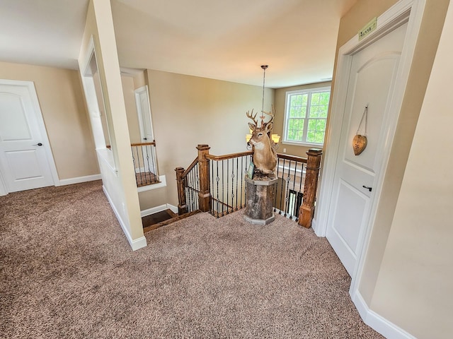 2971 Ownby Rd, Lewisburg, TN 37091 - hallway with carpet floors, baseboards, a chandelier, and an upstairs landing