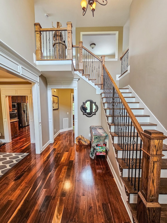 2971 Ownby Rd, Lewisburg, TN 37091 - stairway with baseboards, an inviting chandelier, wood finished floors, and a towering ceiling