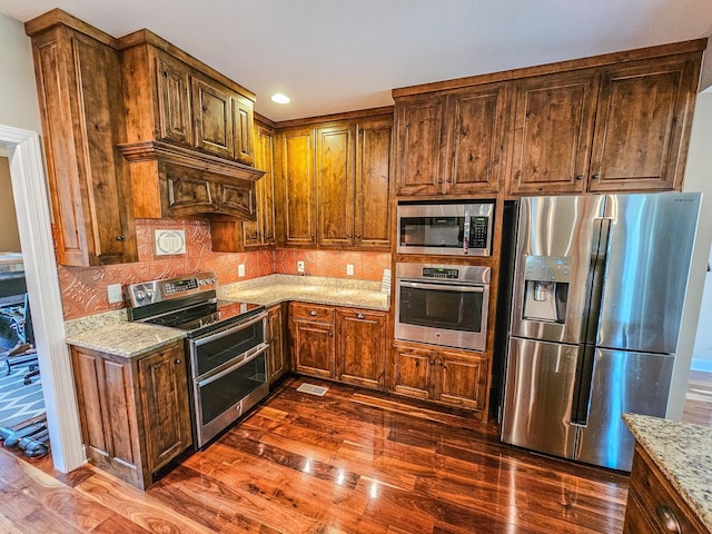 2971 Ownby Rd, Lewisburg, TN 37091 - kitchen featuring stainless steel appliances, light stone countertops, dark wood finished floors, and decorative backsplash