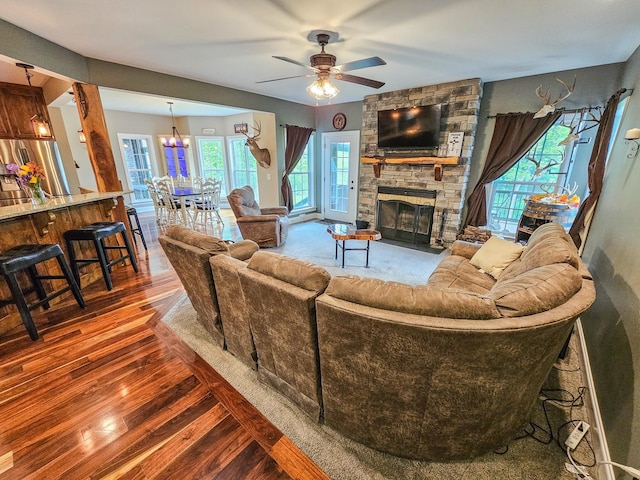 2971 Ownby Rd, Lewisburg, TN 37091 - living area featuring a fireplace, ceiling fan with notable chandelier, and hardwood / wood-style flooring