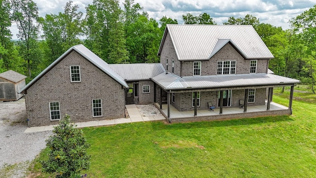 2971 Ownby Rd, Lewisburg, TN 37091 - view of front of home with brick siding, metal roof, and a front lawn