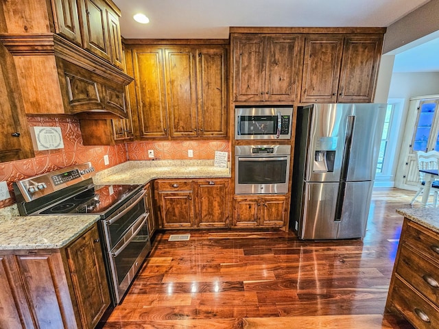 2971 Ownby Rd, Lewisburg, TN 37091 - kitchen with decorative backsplash, visible vents, appliances with stainless steel finishes, light stone countertops, and dark wood-style floors