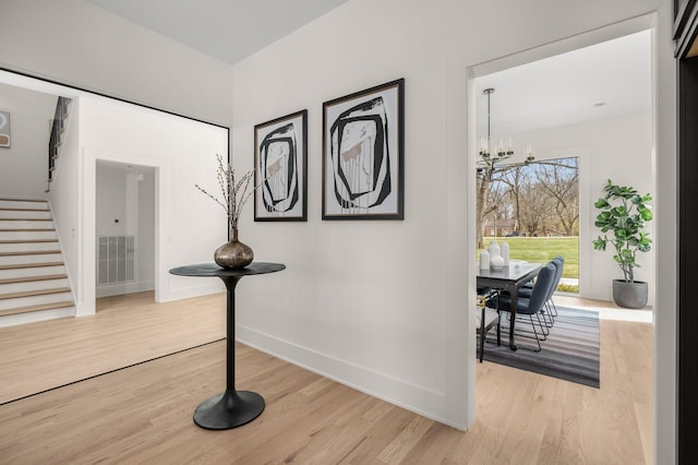 6120 Bresslyn Rd, Nashville, TN 37205 - hall with stairs, light wood-style flooring, and a chandelier