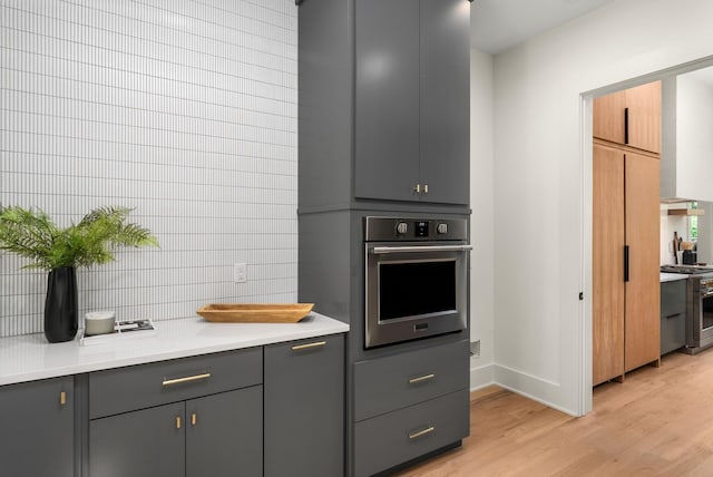 6120 Bresslyn Rd, Nashville, TN 37205 - kitchen with stainless steel appliances, gray cabinetry, light wood-style flooring, and light countertops