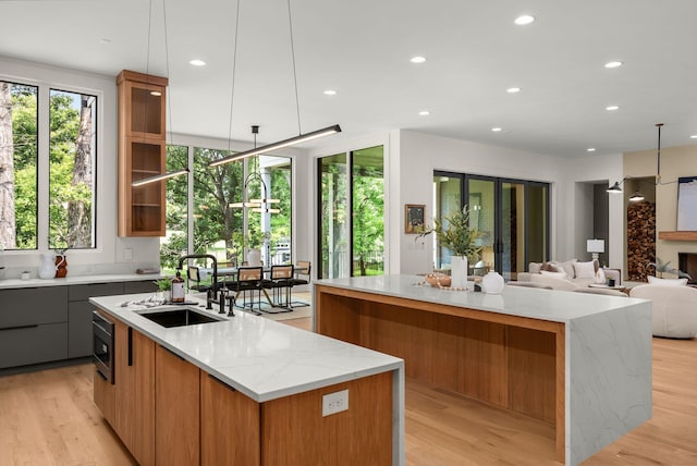 6120 Bresslyn Rd, Nashville, TN 37205 - kitchen with a spacious island, modern cabinets, light stone countertops, light wood-style floors, and recessed lighting