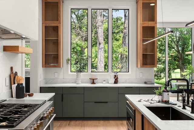 6120 Bresslyn Rd, Nashville, TN 37205 - kitchen featuring gray cabinetry, appliances with stainless steel finishes, light stone counters, glass insert cabinets, and open shelves