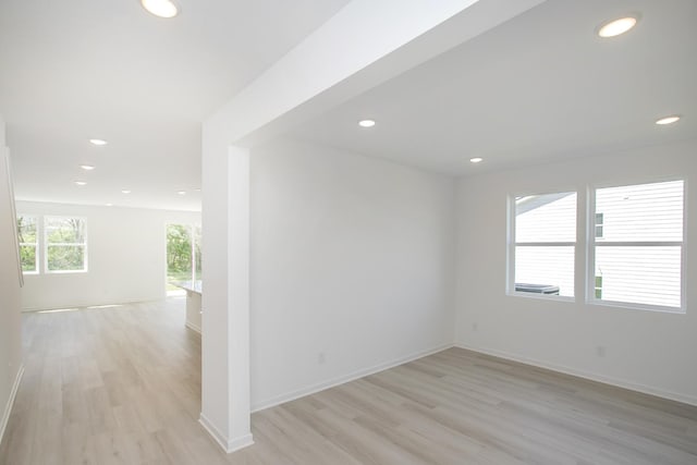 unfurnished room with recessed lighting, baseboards, and light wood-style flooring