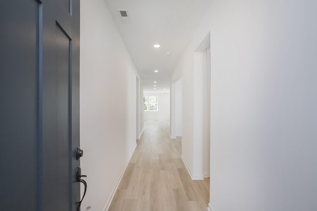 hall featuring recessed lighting, light wood-style flooring, and baseboards