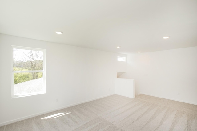 unfurnished room featuring recessed lighting, carpet flooring, and a healthy amount of sunlight
