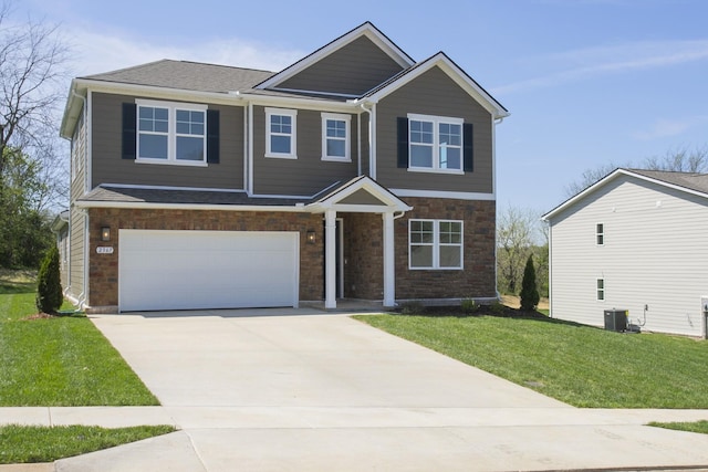 craftsman house with a front yard, central AC unit, a garage, concrete driveway, and stone siding