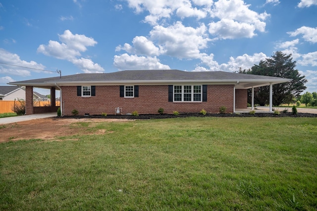 view of front facade with an attached carport, driveway, and brick siding