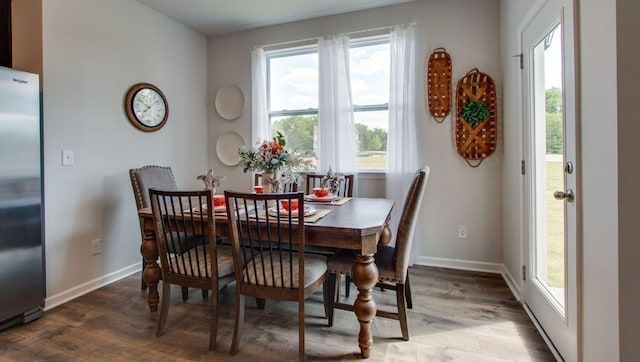 dining area featuring baseboards and wood finished floors