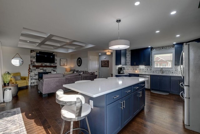 111 Thacker Dr, Portland, TN 37148 - kitchen featuring coffered ceiling, stainless steel appliances, blue cabinets, and dark wood-style floors