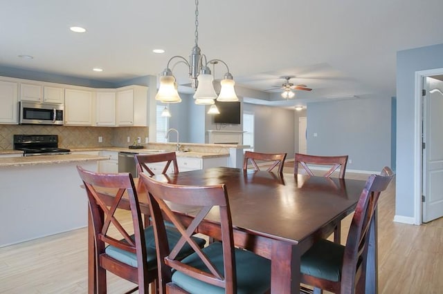 dining area featuring a ceiling fan, baseboards, recessed lighting, and light wood-style floors