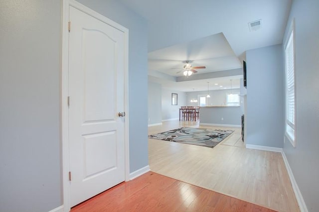 interior space with visible vents, baseboards, ceiling fan, and wood finished floors