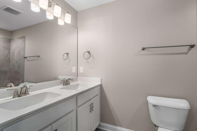 full bath featuring visible vents, a sink, double vanity, and toilet