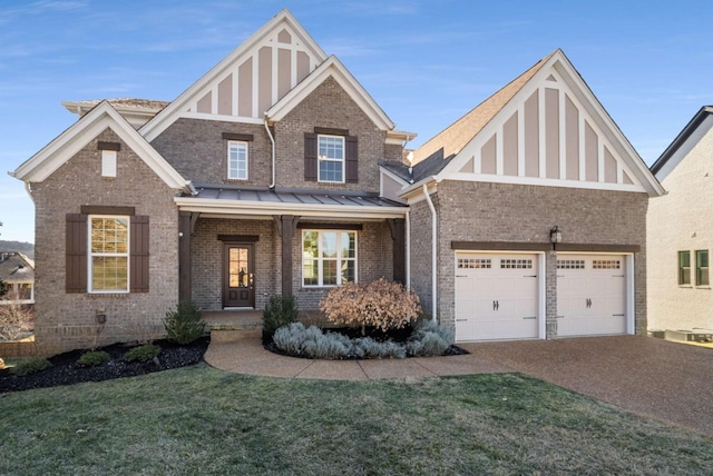 view of front of home featuring brick siding, a garage, a front lawn, and driveway