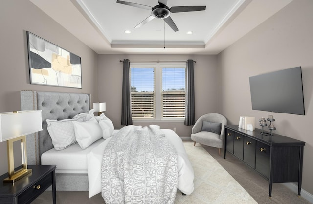 bedroom featuring carpet flooring, ceiling fan, recessed lighting, baseboards, and a tray ceiling