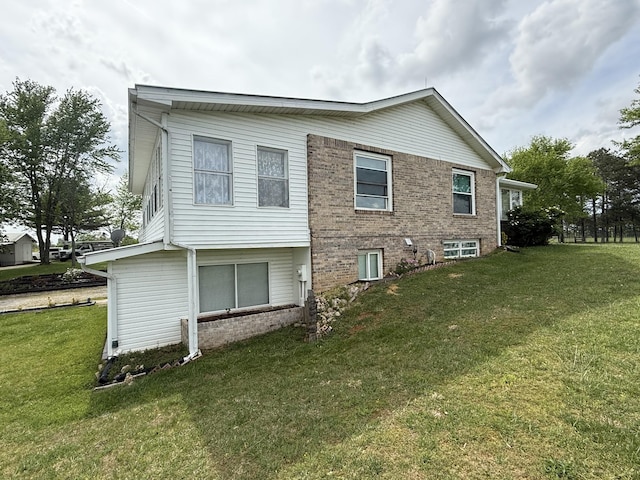 view of side of home with a lawn
