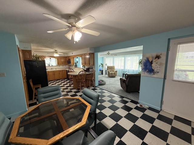 dining area with light floors, a ceiling fan, and a wealth of natural light