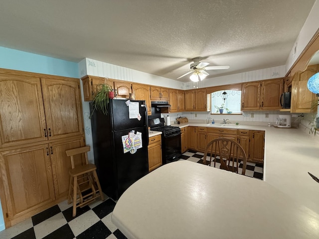 kitchen featuring exhaust hood, a ceiling fan, a sink, tile patterned floors, and black appliances