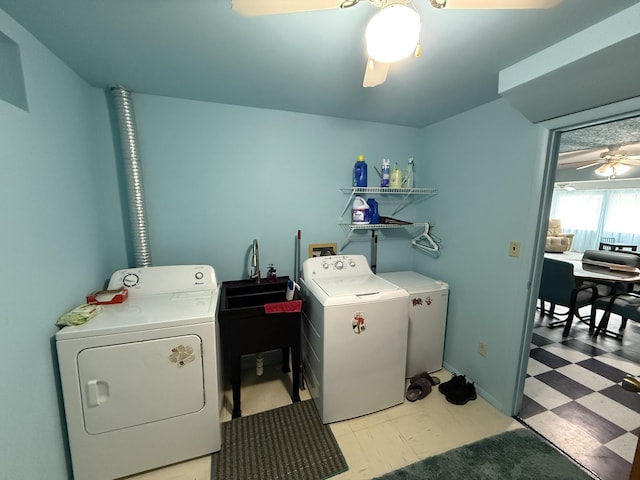 washroom featuring laundry area, a ceiling fan, washing machine and dryer, a sink, and light floors