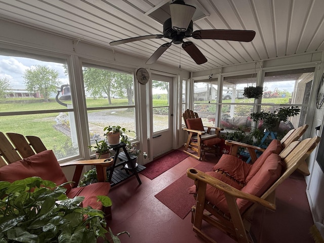 sunroom / solarium with plenty of natural light and ceiling fan