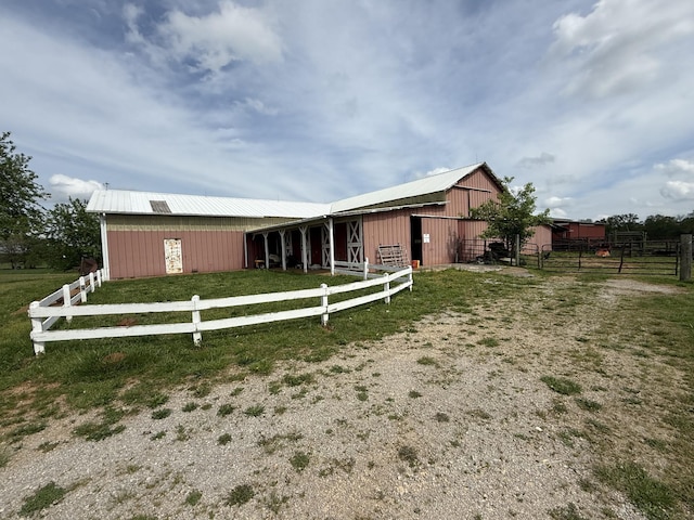 exterior space featuring an outdoor structure, an exterior structure, and metal roof
