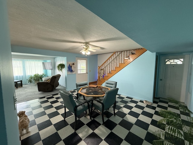 dining area with baseboards, stairway, a textured ceiling, tile patterned floors, and a ceiling fan