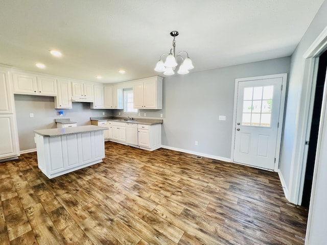 436 White Rd, Leoma, TN 38468 - kitchen featuring a kitchen island, white dishwasher, white cabinets, dark wood-style floors, and a notable chandelier