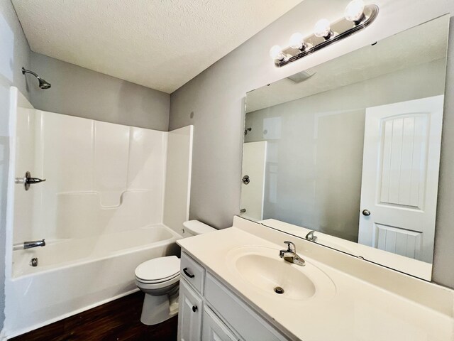 436 White Rd, Leoma, TN 38468 - full bathroom with vanity, toilet, a textured ceiling, shower / washtub combination, and wood finished floors