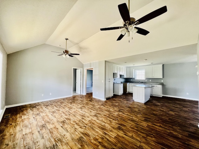 436 White Rd, Leoma, TN 38468 - unfurnished living room with ceiling fan, visible vents, baseboards, dark wood-type flooring, and vaulted ceiling