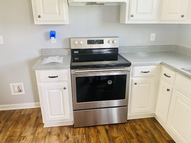436 White Rd, Leoma, TN 38468 - kitchen with light countertops, exhaust hood, white cabinets, and electric stove