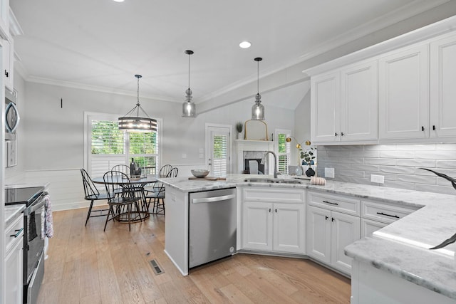 1209 Janie Sue Ct, Lebanon, TN 37087 - kitchen with appliances with stainless steel finishes, a sink, white cabinets, a peninsula, and pendant lighting