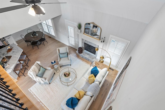 1209 Janie Sue Ct, Lebanon, TN 37087 - living room featuring wood finished floors, a ceiling fan, a fireplace, and vaulted ceiling