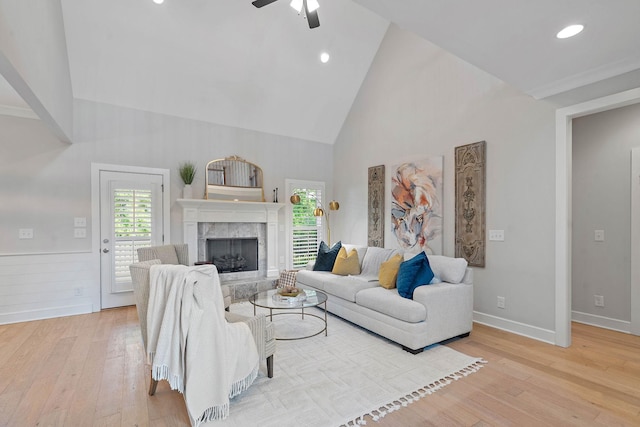 1209 Janie Sue Ct, Lebanon, TN 37087 - living room with high vaulted ceiling, light wood finished floors, ceiling fan, a fireplace, and baseboards
