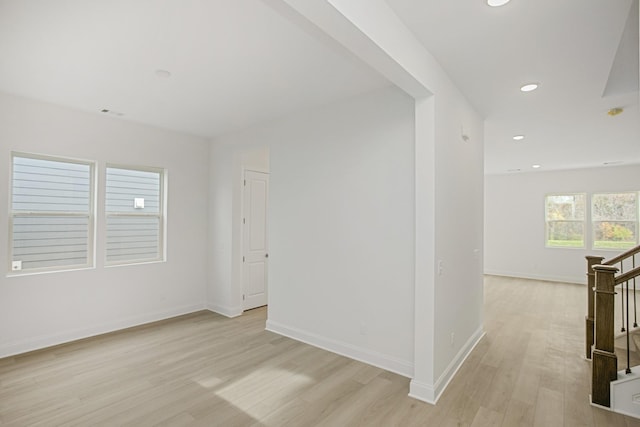 spare room with recessed lighting, light wood-style flooring, and baseboards