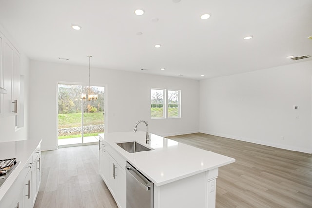 kitchen featuring visible vents, appliances with stainless steel finishes, a sink, light wood finished floors, and a chandelier