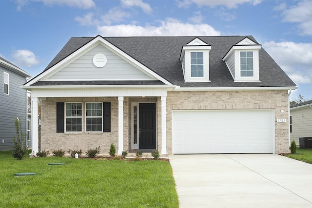 view of front of house featuring concrete driveway, brick siding, a shingled roof, and a front yard