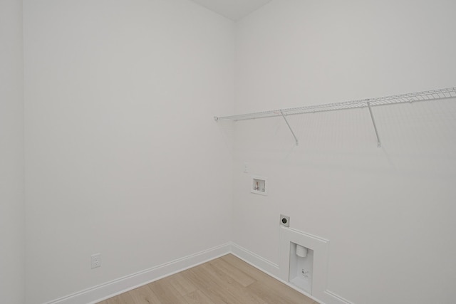 washroom featuring laundry area, light wood finished floors, hookup for a washing machine, baseboards, and hookup for an electric dryer