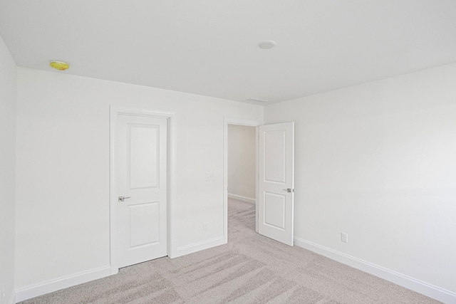 carpeted empty room with baseboards