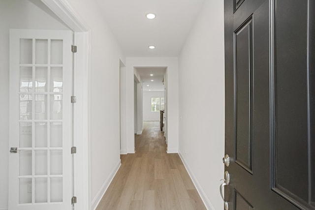 hall with light wood-type flooring, recessed lighting, and baseboards