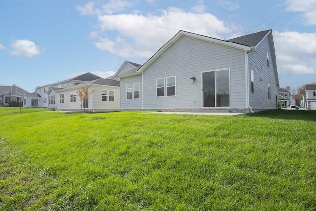 rear view of house with a lawn