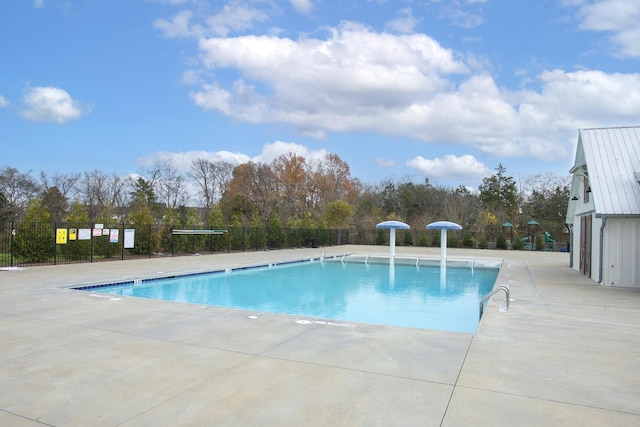 pool featuring a patio and fence