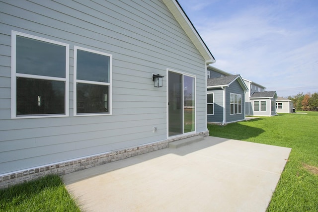 back of house featuring a patio and a yard