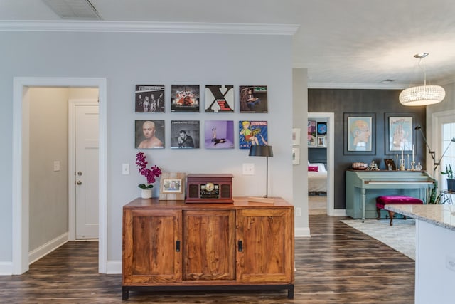 hallway with crown molding, dark wood-style flooring, and baseboards