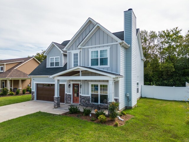 craftsman-style home featuring board and batten siding, a porch, a chimney, fence, and a front lawn