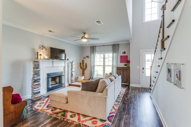living room featuring stairway, dark wood-style flooring, and visible vents