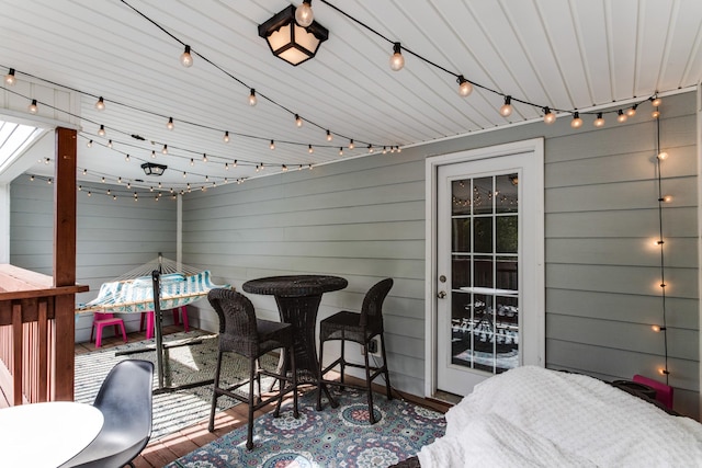 wooden terrace with outdoor dining area and a patio area